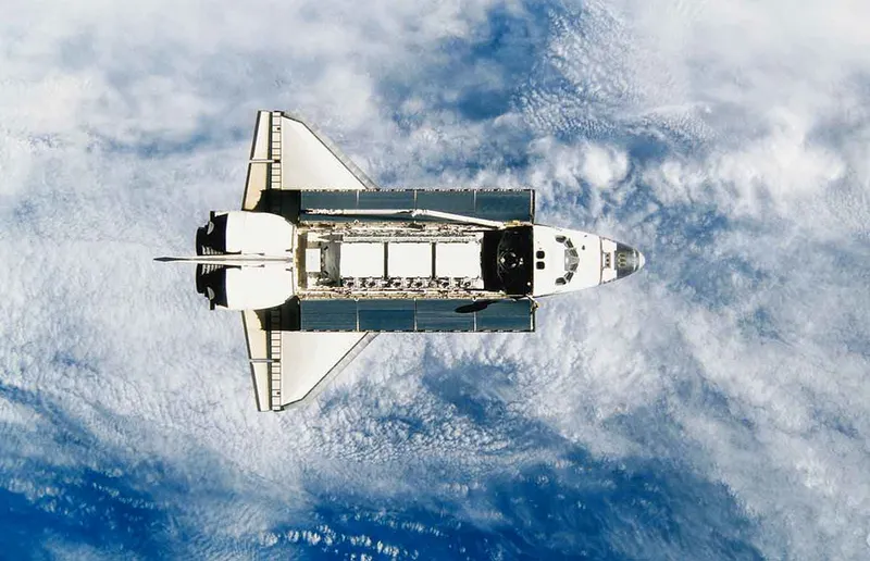 Space shuttle orbiting earth, satellite view 