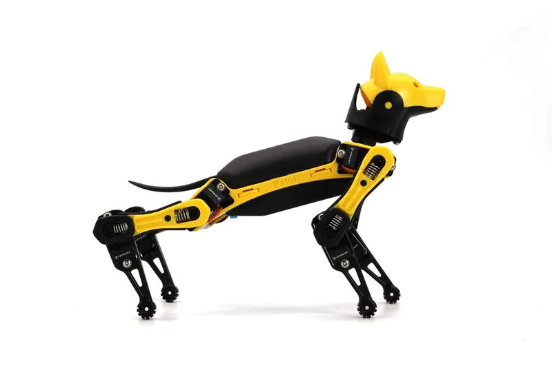 A small yellow and black robot dog about the size of a hand