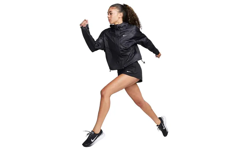 A woman wearing while wearing the Nike Aerogami jacket in black