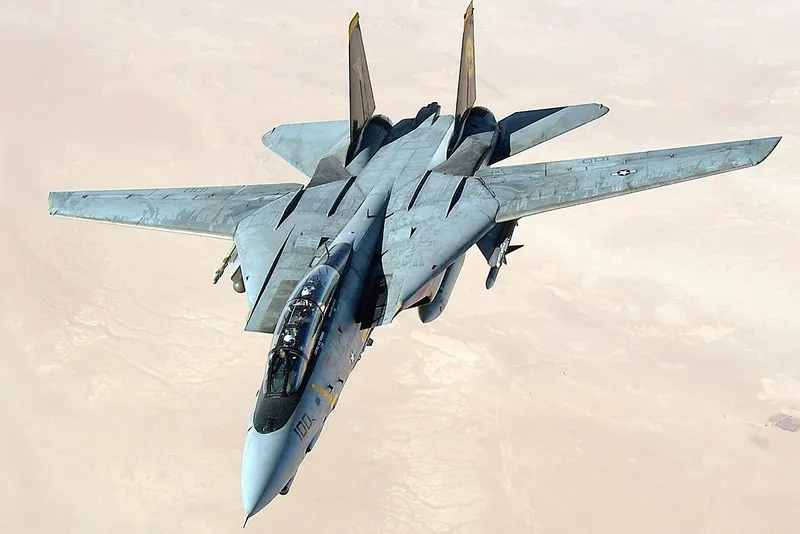 fighter jet flying over desert
