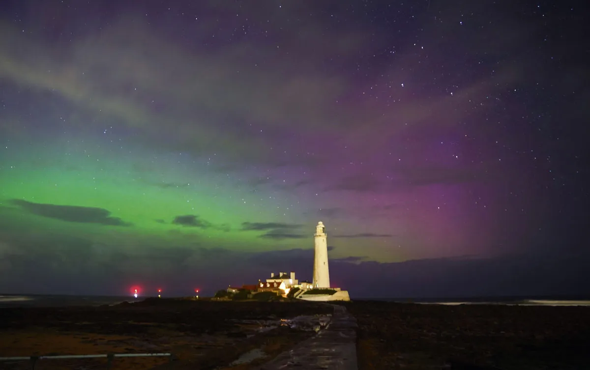 The northern lights (aurora borealis) over St Mary's lighthouse in Whitley Bay on the north east coast of England.