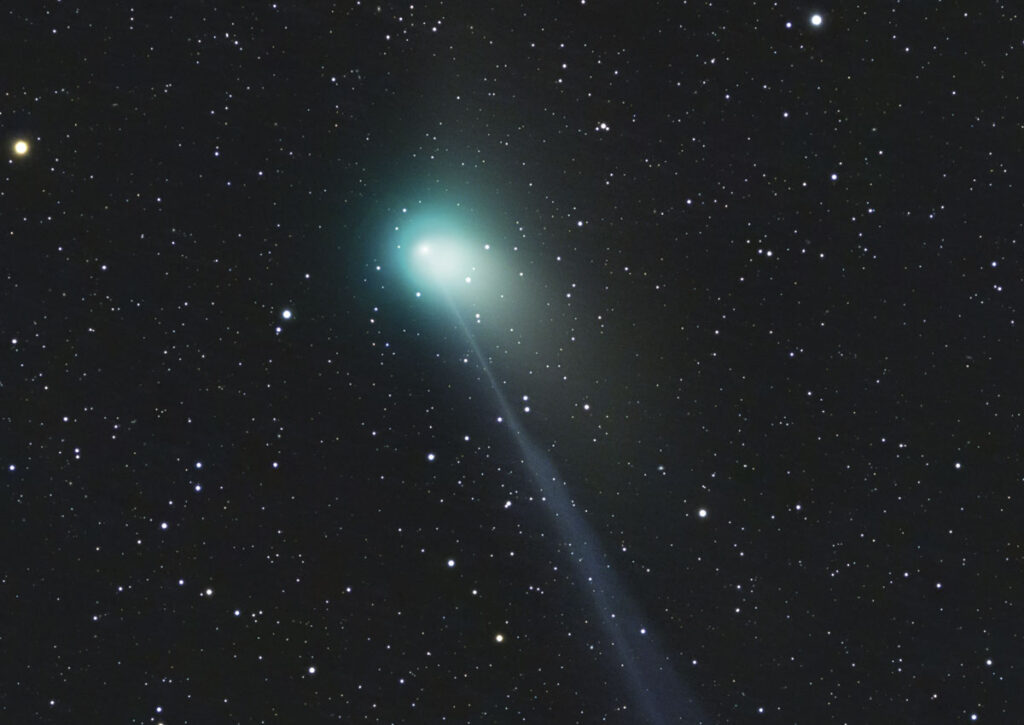 Green comet in night sky