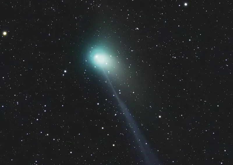 Green comet in night sky
