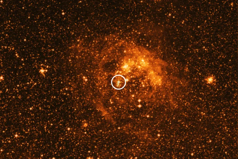 Bright orange/white star in deep space circled in white with orange clouds