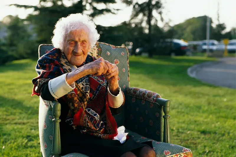 Jeanne Calment the longest-living human ever sits in a chair outside