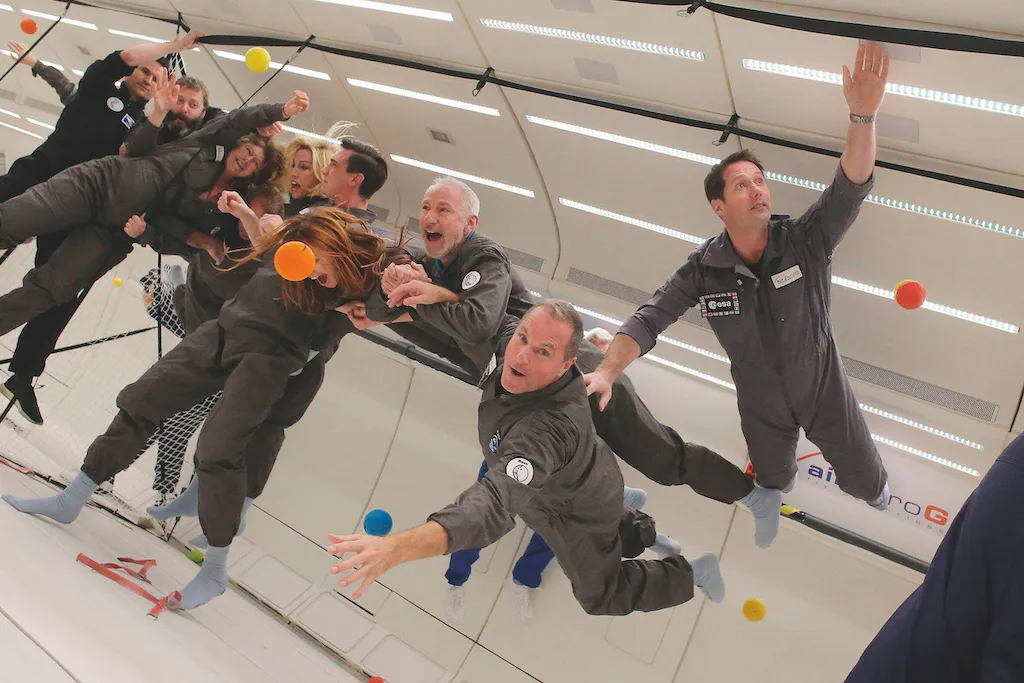 A photograph of a crew experiencing weightlessness on a parabolic flight