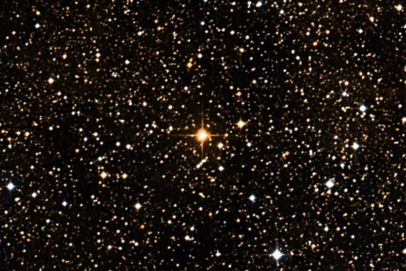 Bright orange star surrounded by smaller stars