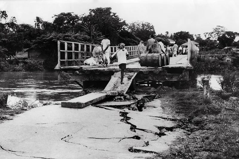 child crossing damaged bridge with cracks in the road