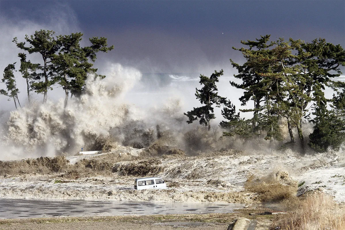 huge waves crash over trees and cars