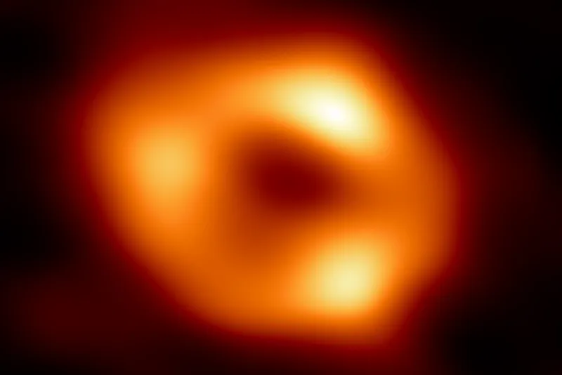 A glowing hot ring of material surrounds the central dark shadow of the black hole.
