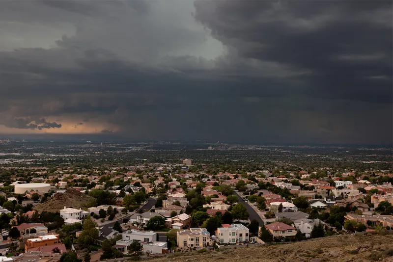 Aerial view of city with storm clouds.