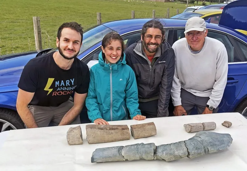 Four researchers sit behind the jawbone discovery of a giant marine reptile