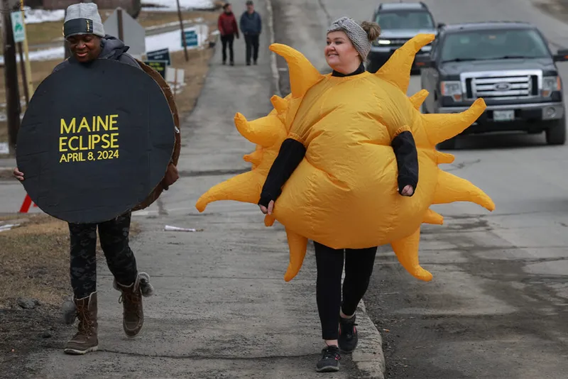 Man dressed as Moon and woman dressed as Sun.