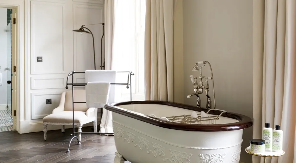 An antique bathtub in a pale grey room at No. 131 in Cheltenham