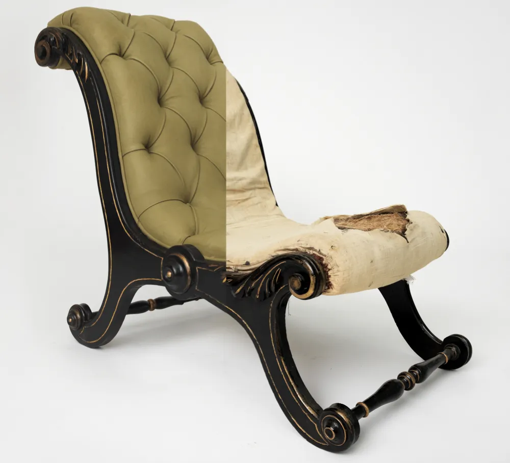 An antique button-back chair with half of the upholstery removed