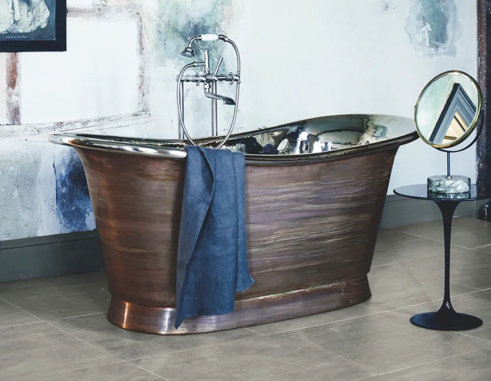 Fired Earth's copper 'Babylon' bath (from £5,750) features a polished nickel interior, is available in three sizes, and is shown here with 'Mademoiselle' bath and shower mixer in brushed nickel (£1,175)