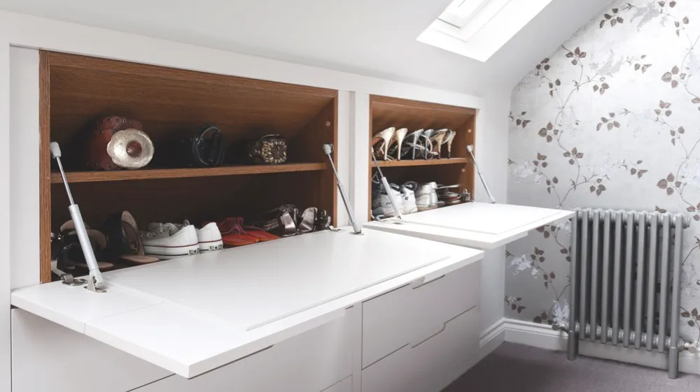 Drawers and oak-lined shoe shelves are built into the eaves in this attic bedroom. Bespoke fitted furniture designed by Barbara Genda is from £1,200 per linear metre