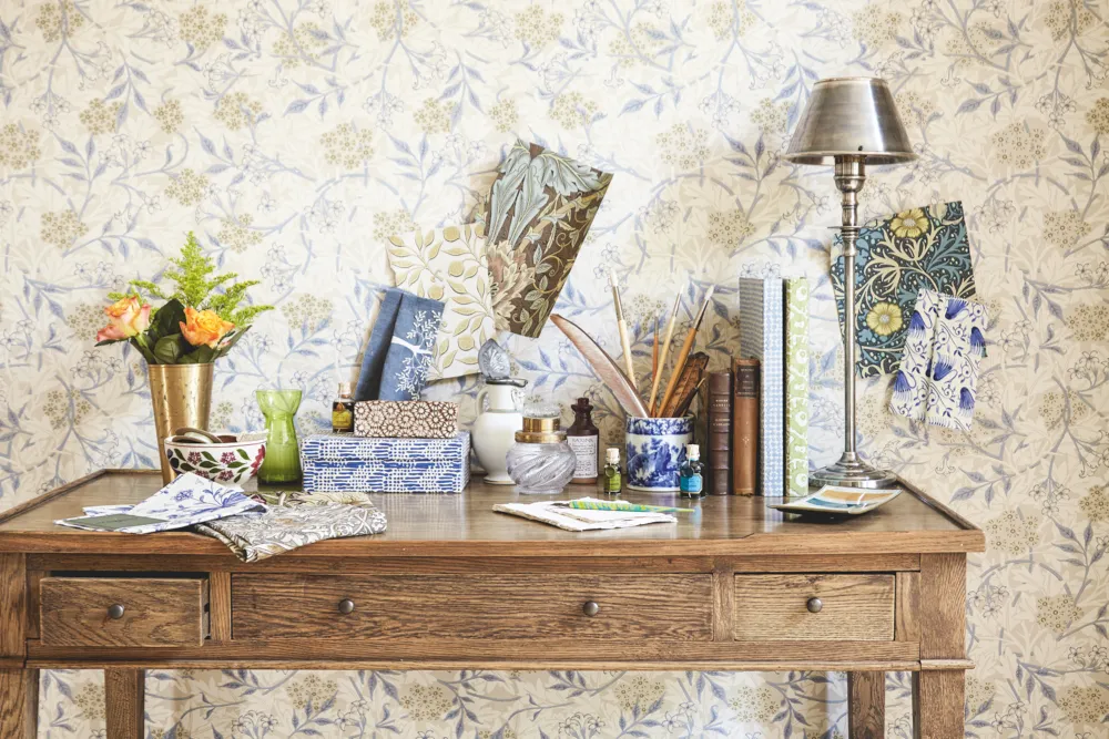 A console table peppered with William Morris papers