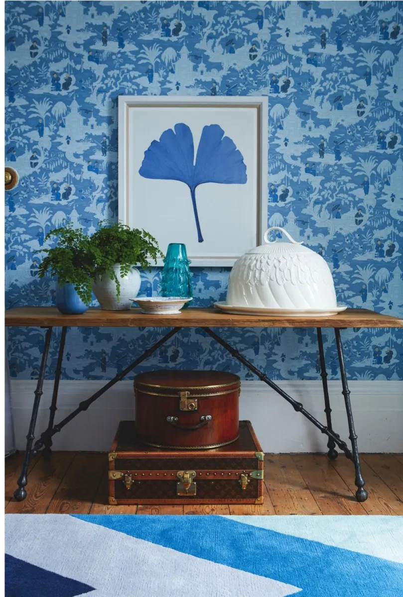 Luggage: Round hat box, as before. 1970s Louis Vuitton shoe case, £5,500, Oliver Oulton at The Furniture Cave. Other items: Chinese toile wallpaper, as before. Ginkgo leaf print, £540, Trowbridge Gallery. Reclaimed oak console table, £3,200, Paolo Moschino for Nicholas Haslam. On console, from left: Serex blue glass vase (used as planter), £25, Heal’s. 19th-century French confit jug used as planter, £240, Maison Artefact. 19th-century English porcelain dish, £85, Maison Artefact. Large aqua thistle vase, £165, Paolo Moschino for Nicholas Haslam. Armadale cloche platter, £298, Anthropologie