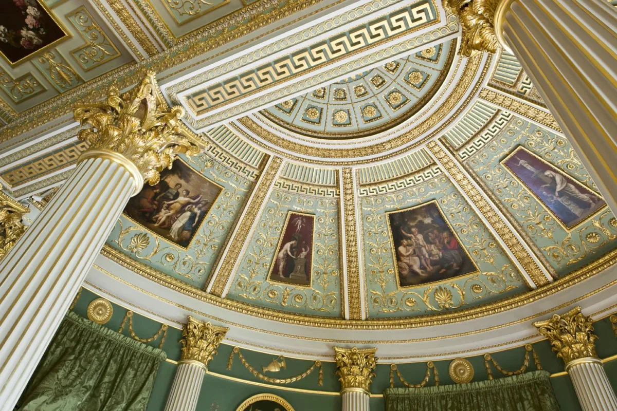 An image of the ornate gold and green ceiling at Spencer House in London