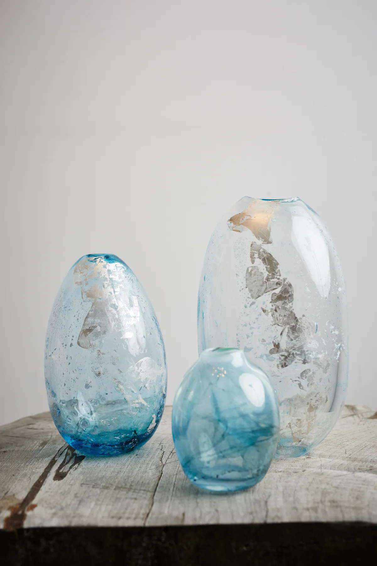 Three of glassblower Laura Smith's handmade glass vessels with flecks of silver