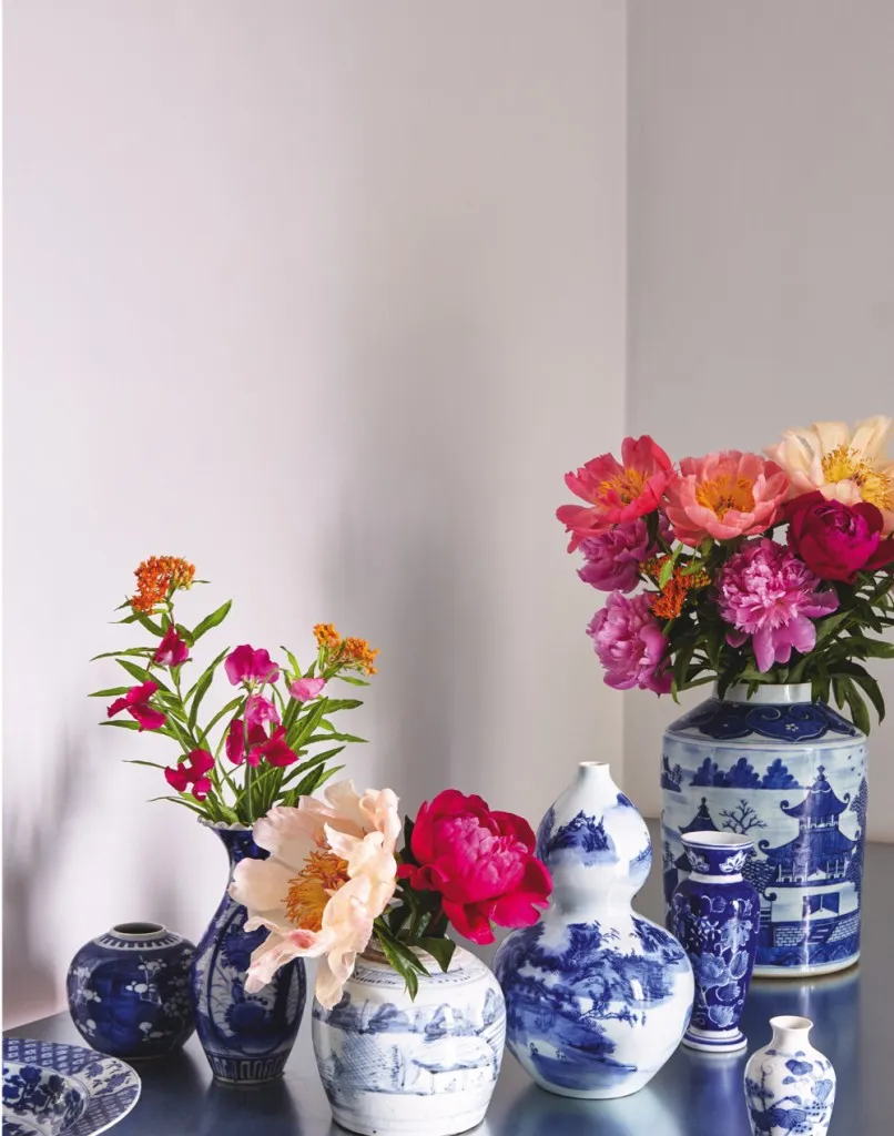 Oriental Blue and White vases filled with fresh flowers on a silver side table