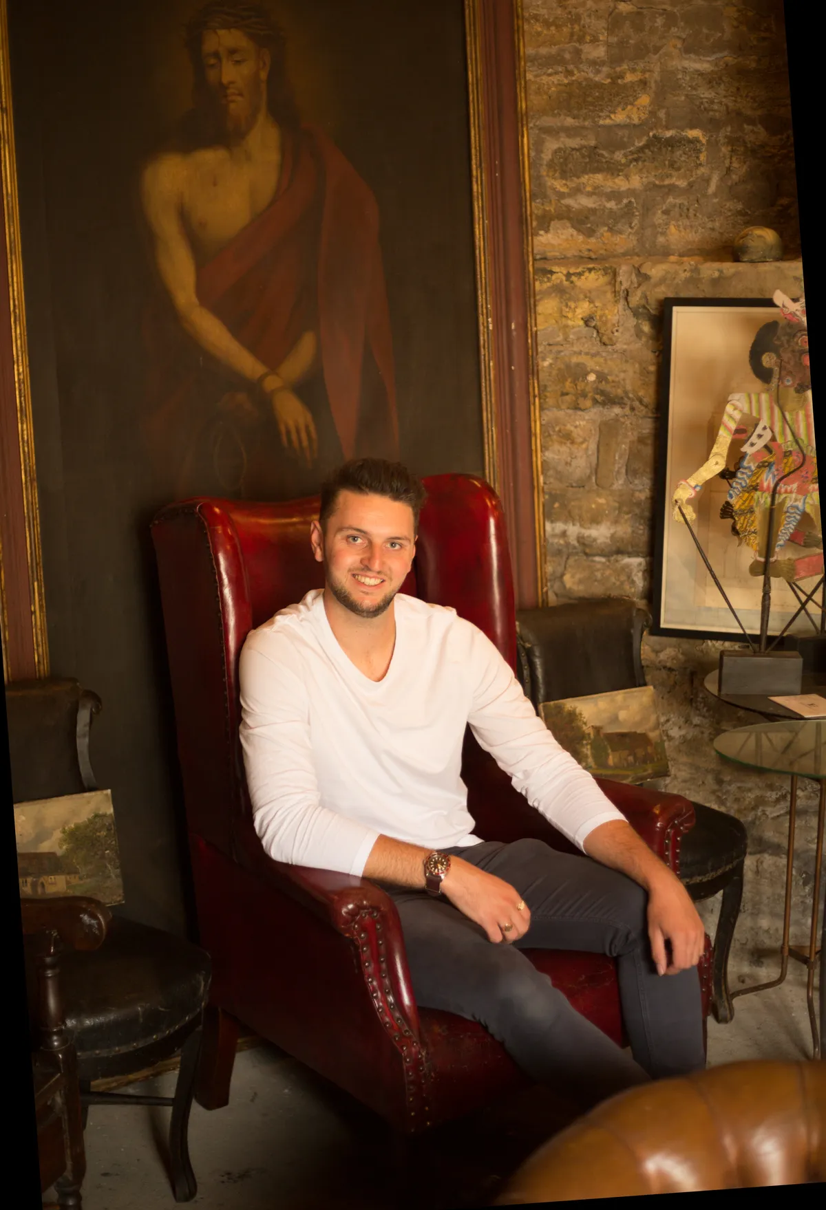 Antiques dealer Matt Dixon sat in a red leather armchair in his shop