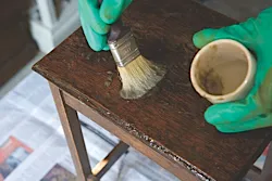 A table being covered with paint varnish