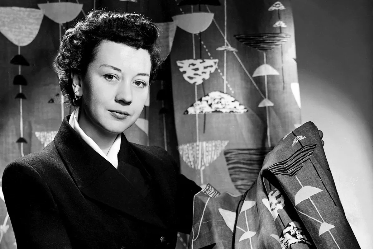 A picture of Lucienne Day holding her 'Calyx' pattern