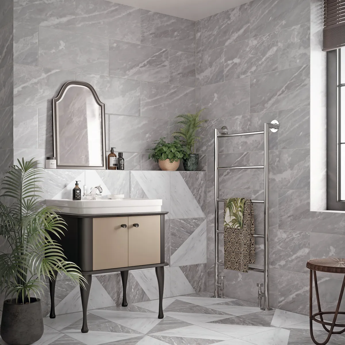 A modern bathroom with grey slate tiles and a silver heated towel rail