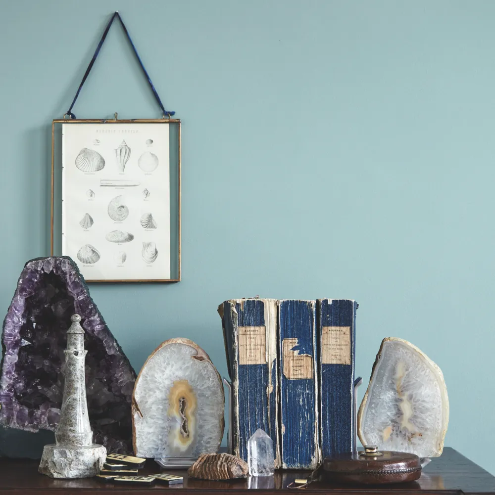 Antique books and crystals grouped on a vintage sideboard