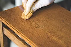 A French polish rubber is being used to polish