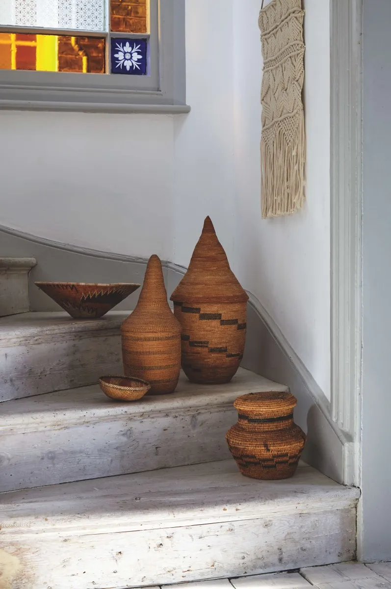 An array of tribal baskets and bowls arranged on a staircase