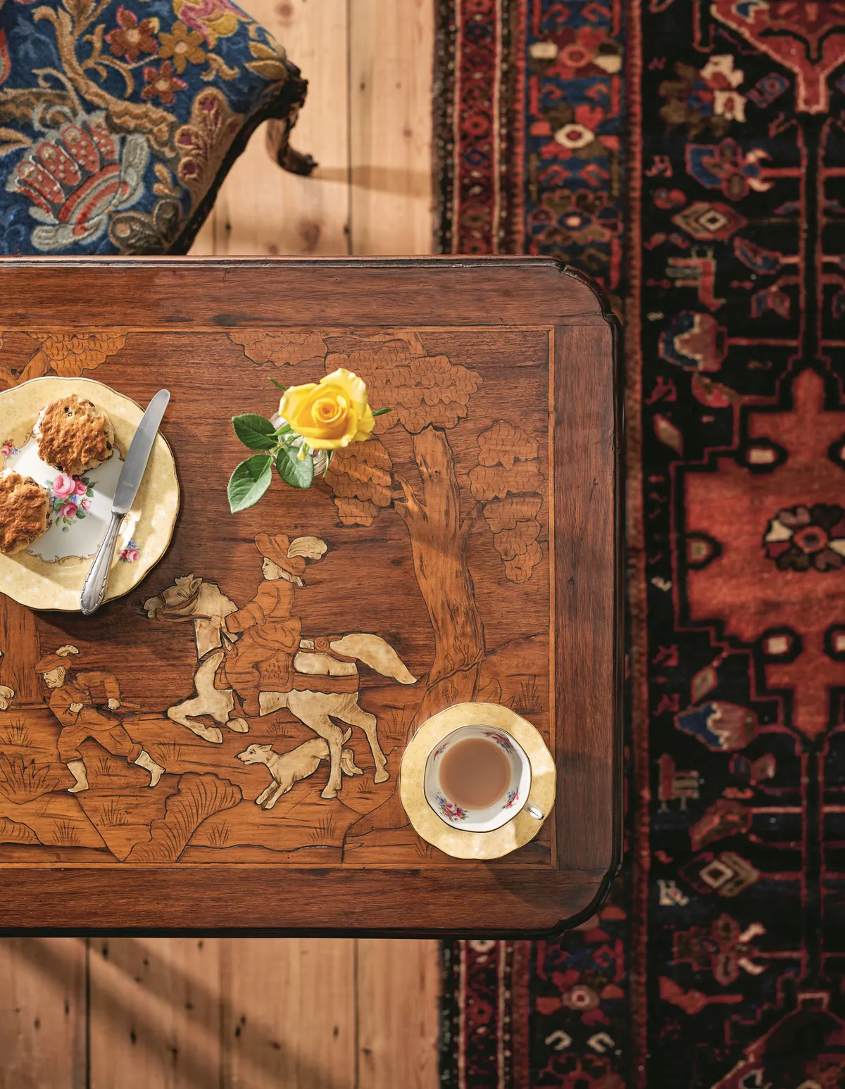 A traditional marquetry coffee table on an antique Persian rug