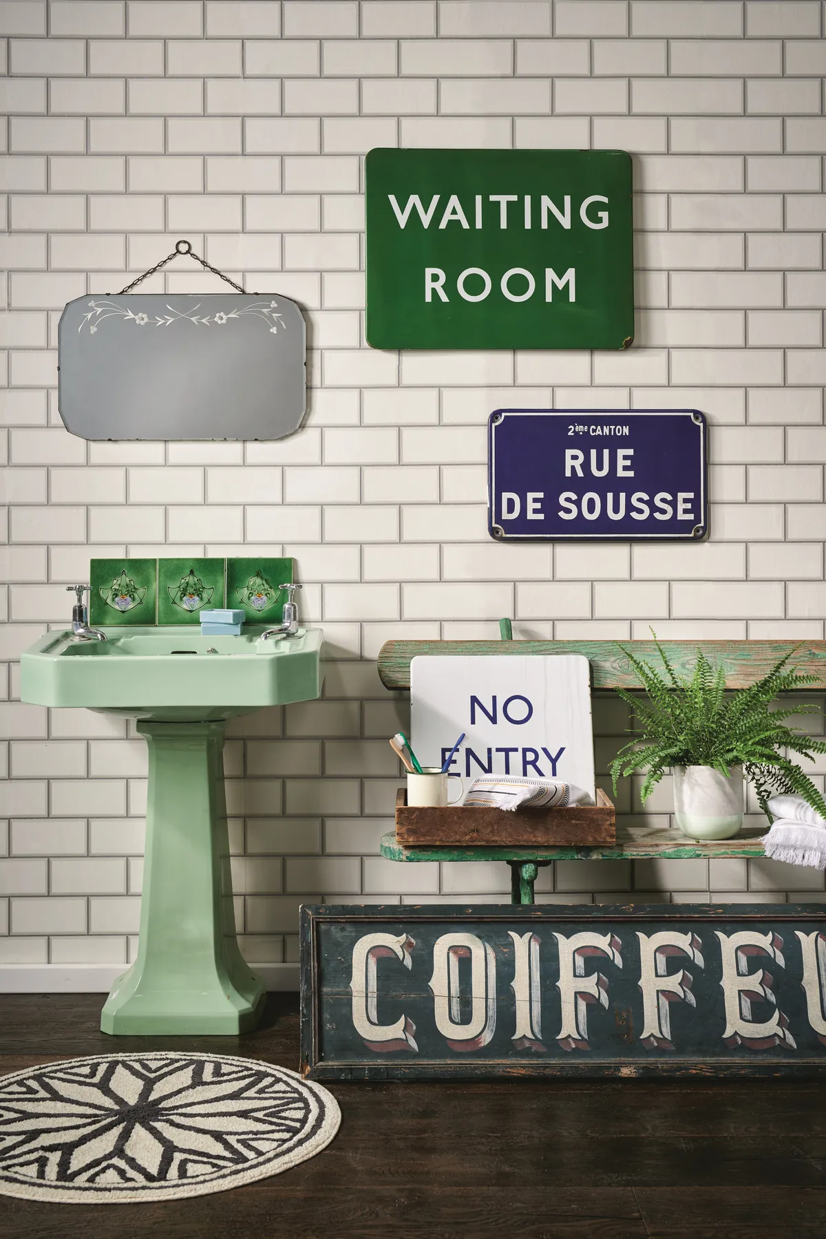 Green vintage signs bring personality to a utilitarian bathroom.