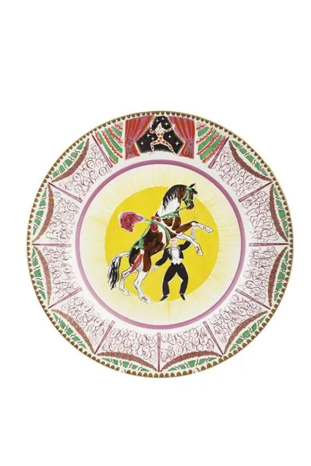 A colourful circus-themed dinner plate picturing a decorated horse and handler