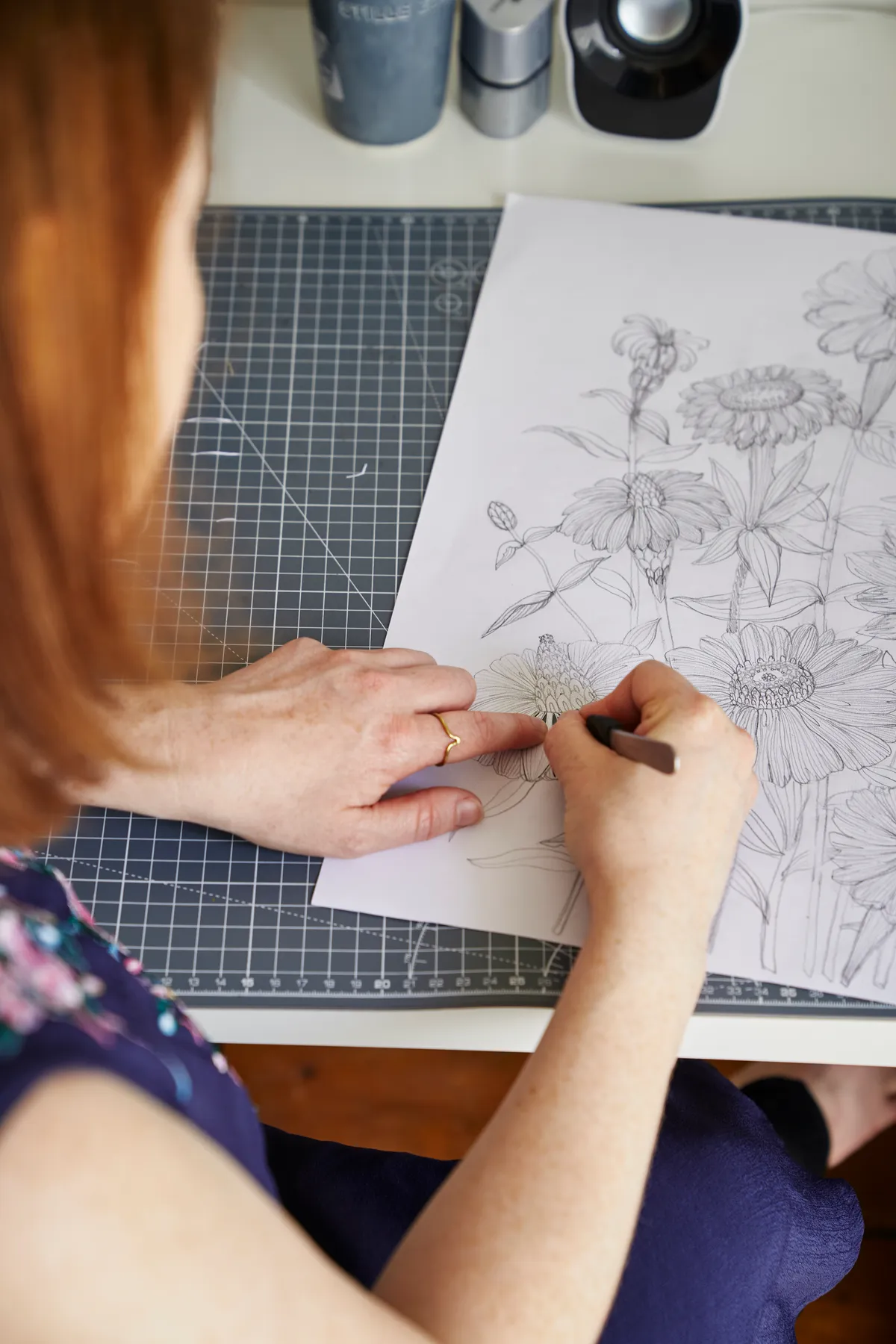 Jessica Baldry sketching out a botanical design before cutting it out