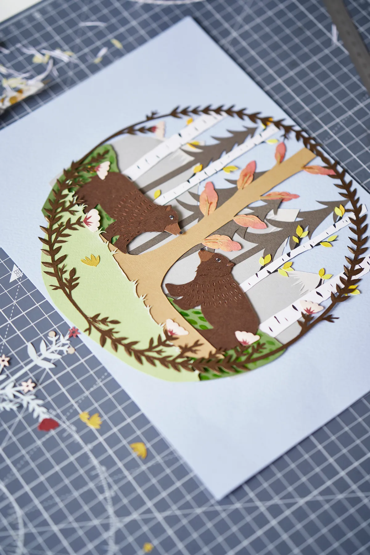 One of Jessica's paper cut designs featuring bears in a woodland scene