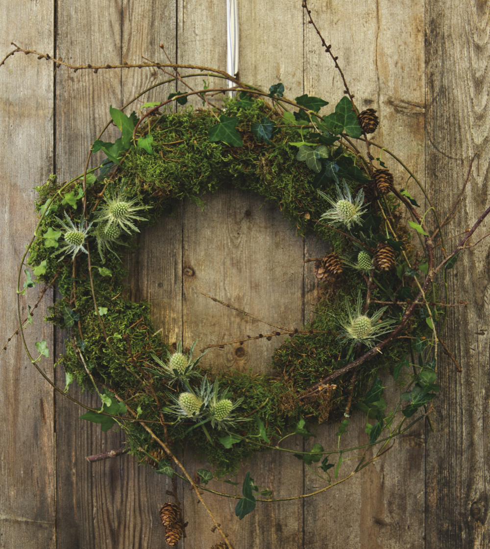 Step 1 - Twigs, dampended moss, ivy and fresh foraged greenery secured to the base of a wreath frame