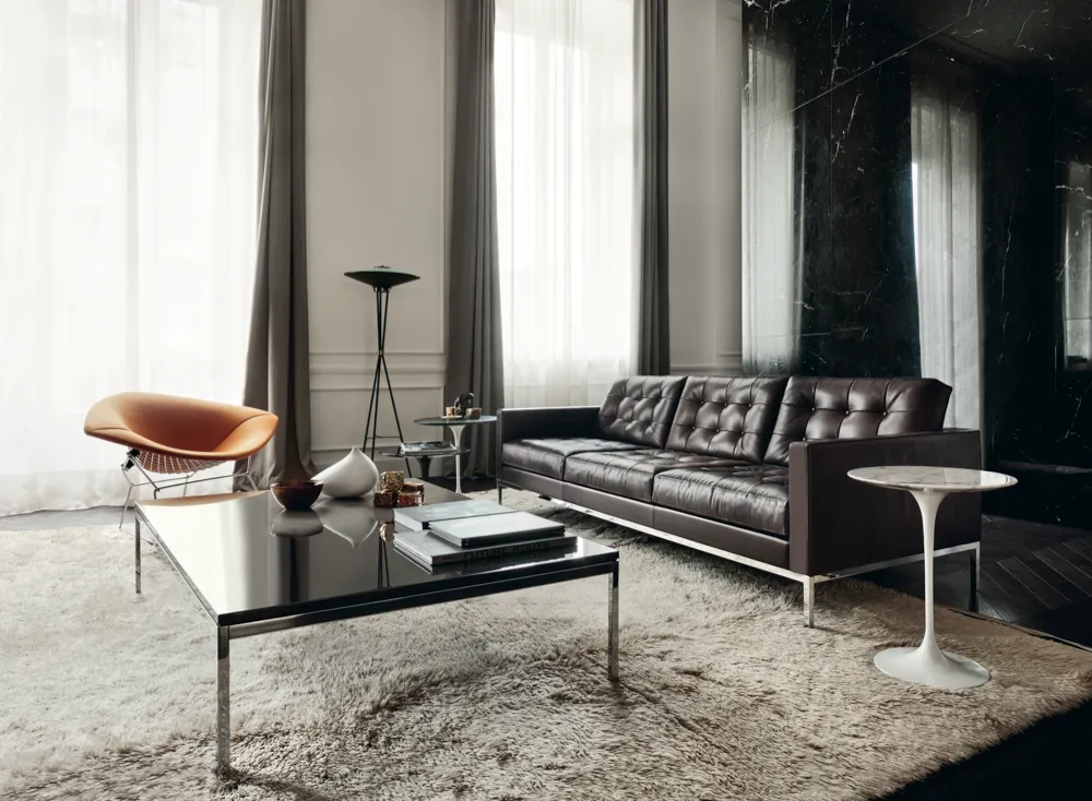 A luxury living room set featuring several of Florence Knoll's iconic original designs, including her 'Relax sofa in dark brown 'Venezia' leather and 'Low Table' with lacquer top