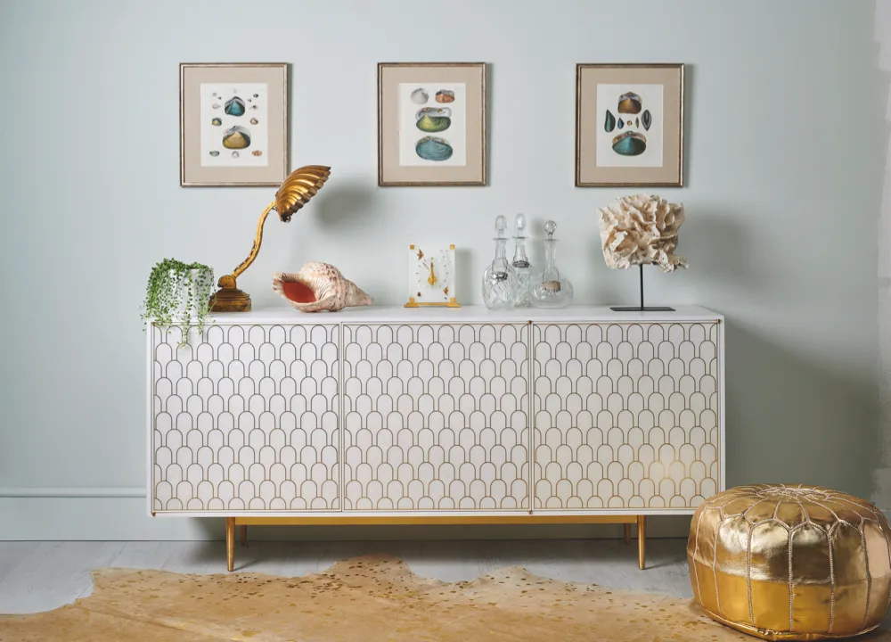 Chic white and gold sideboard styled with oceanic antiques