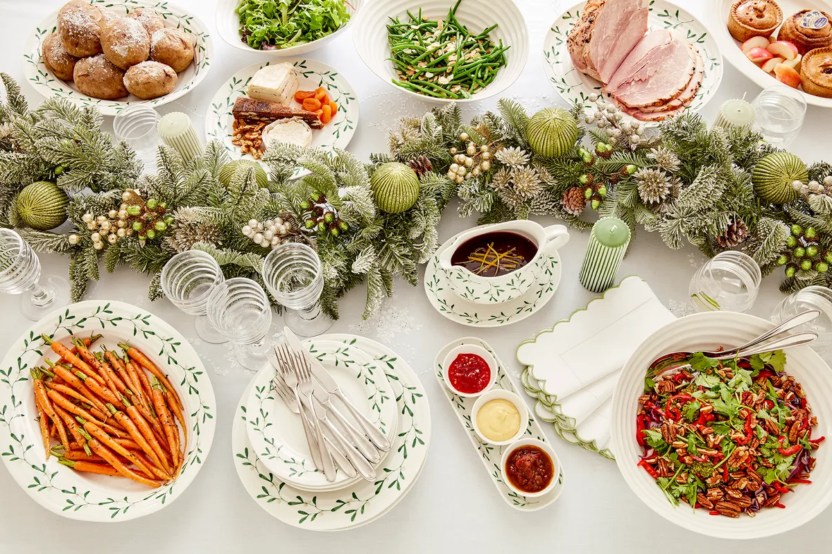 A Christmas dining table laden with food, by Sophie Conran