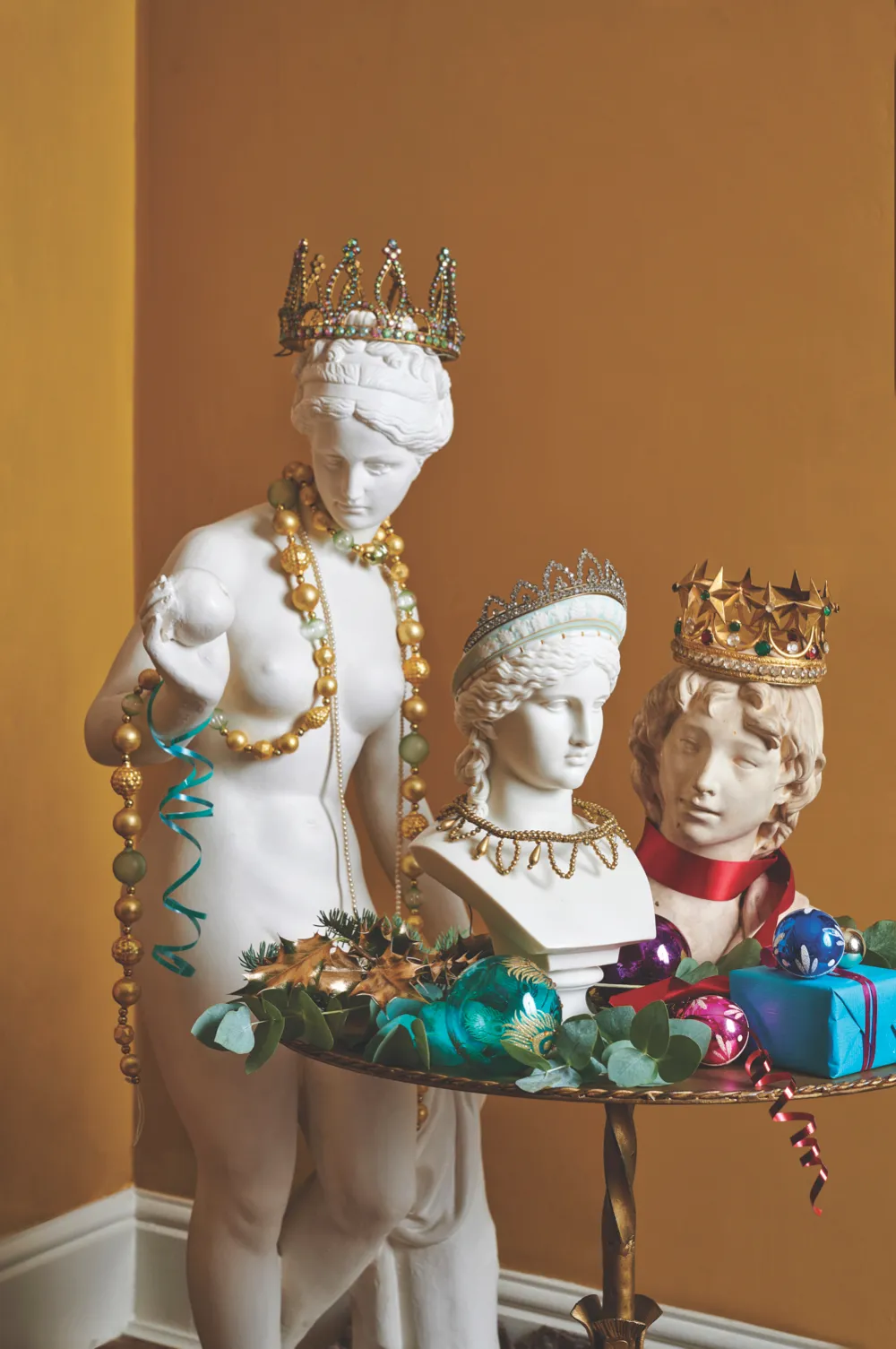 Antique busts decorated with tiaras, crowns and necklaces