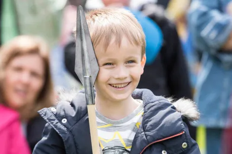 A young boy with a spear at the Tudors at the Tower family festival