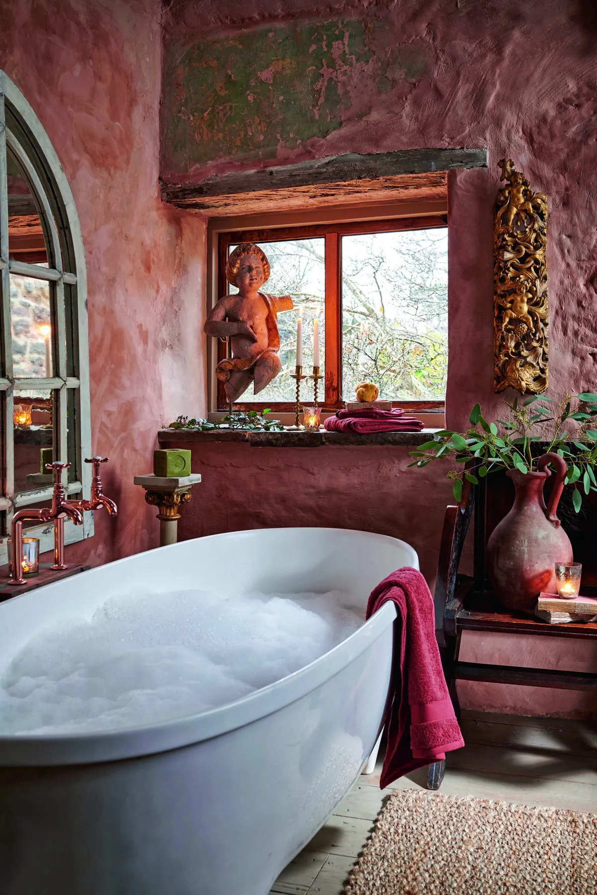An indulgent bathtub surrounded by salvaged church antiques.