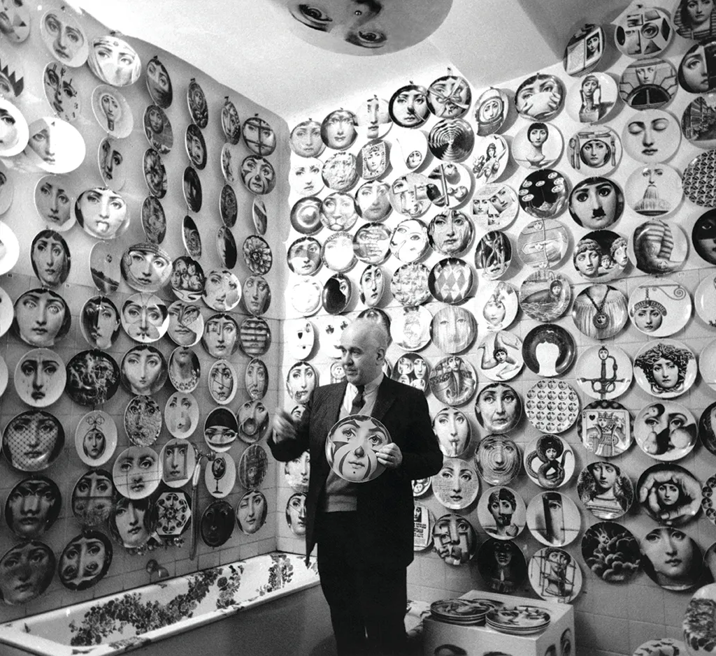 Piero Fornasetti surrounded by his Tema e Variazioni plates.