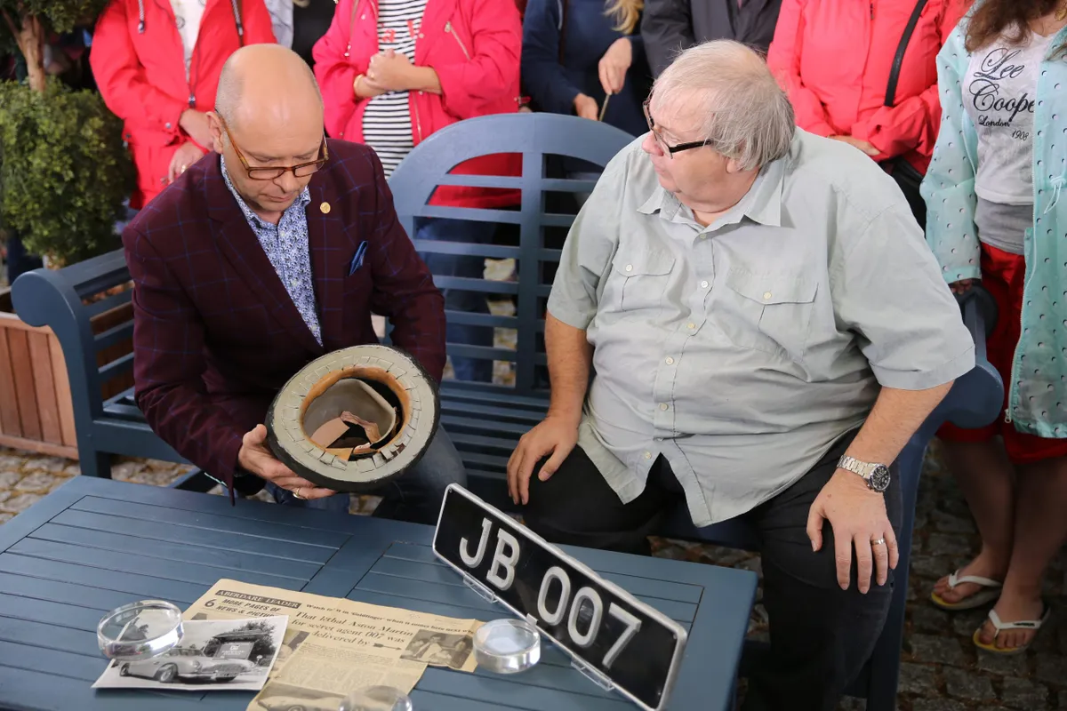 Marc Allum and the owner of Oddjob's bowler hat examine the collection