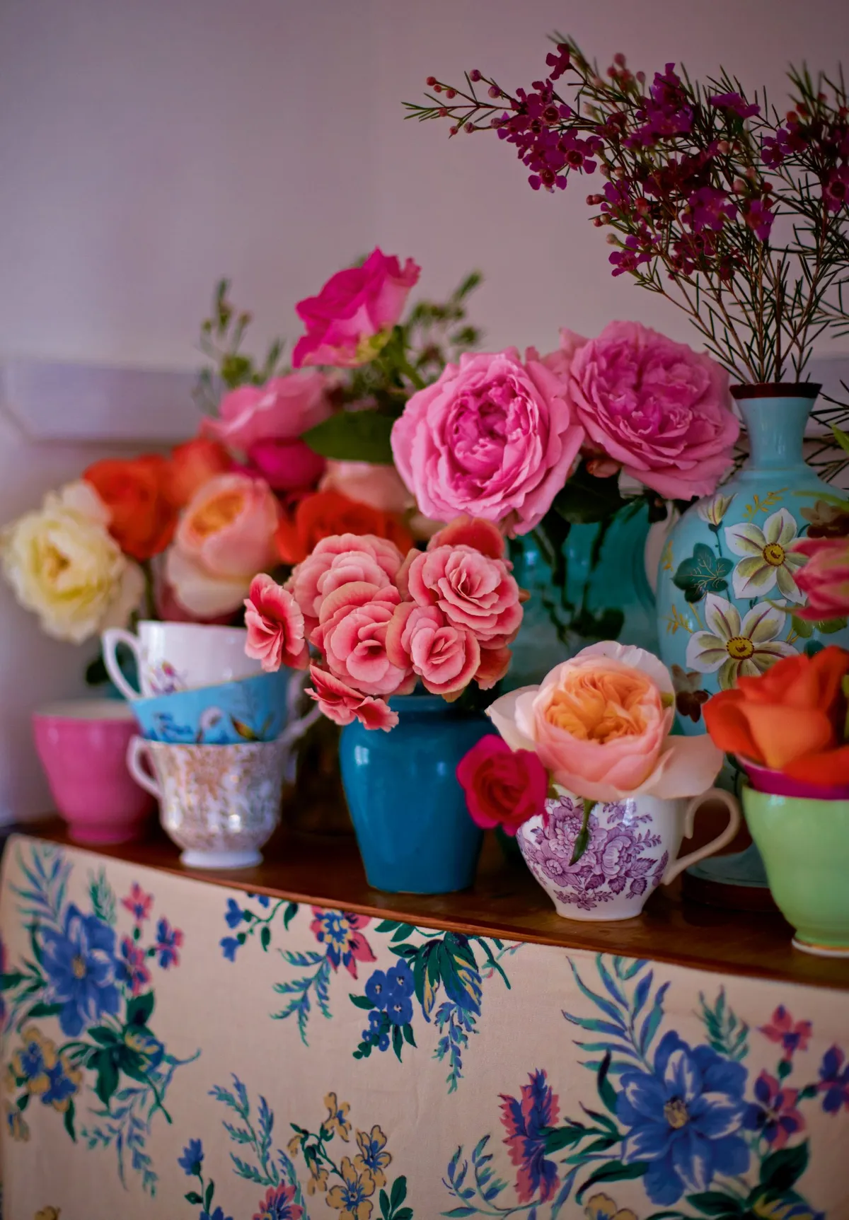 Vintage teacups used to display colourful flowers