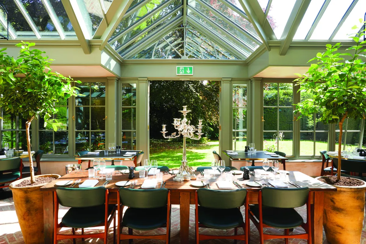 Tuck into classic fare in the light-filled glasshouse restaurant.