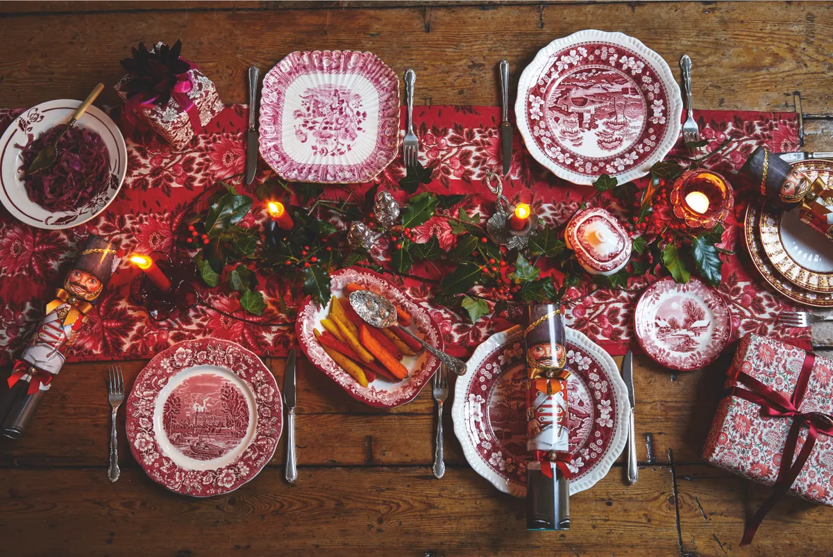 Taking cues from a traditional Victorian Christmas, with a little nod to France, lay the table with crimson plates and serving dishes. Complete the decorations with a festive runner, fresh foliage and candles along the centre to throw a soft glow and create a mellow atmosphere